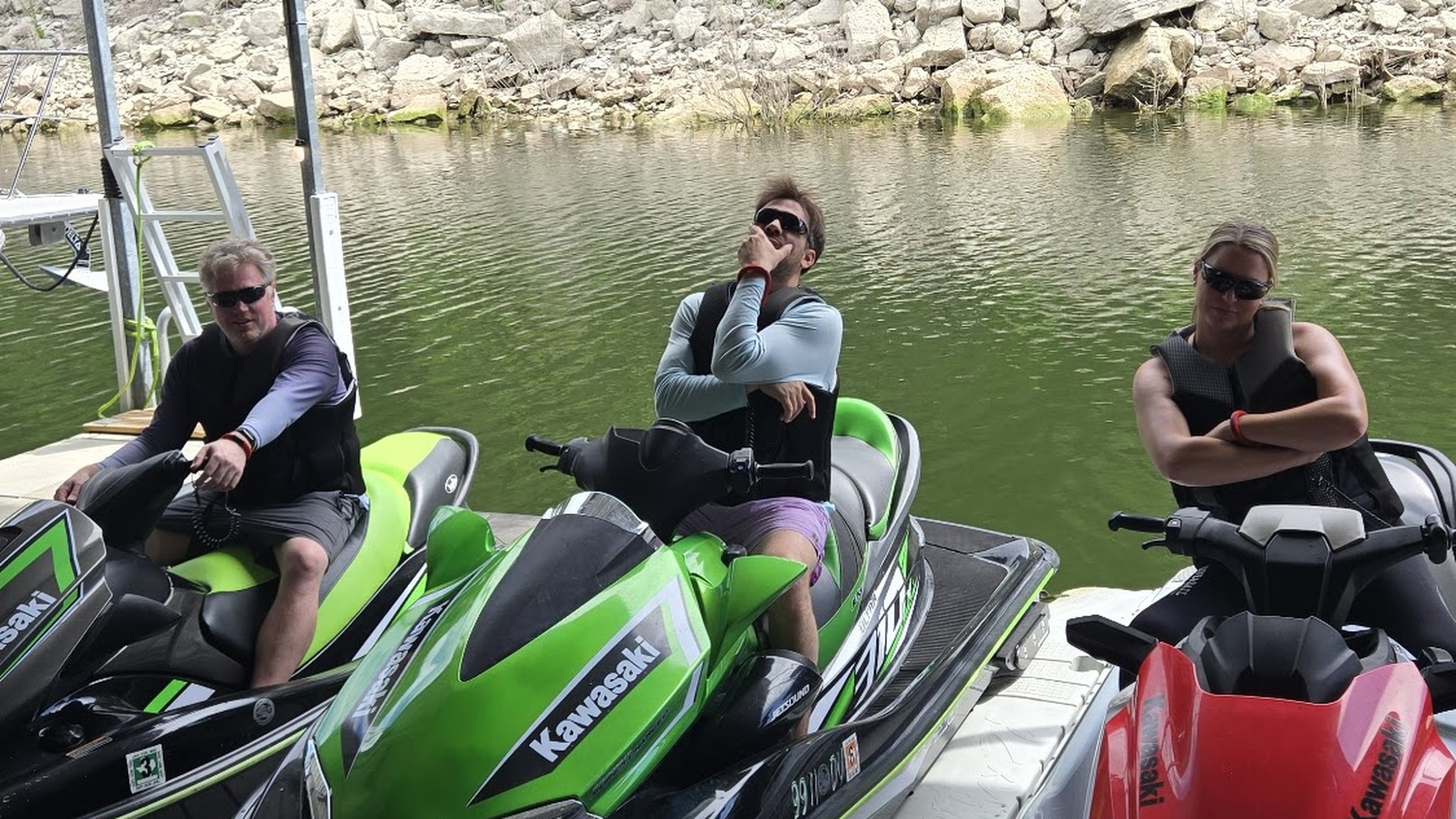 Three guests on jet skis at the private dock
